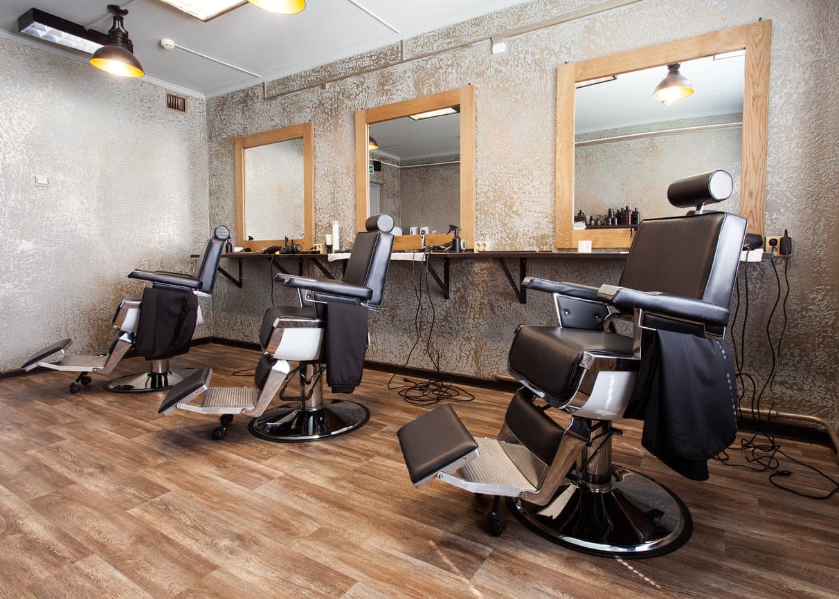 Here's a light and bright barbershop with distressed looking walls against a wood floor. Frankly, I don't like the walls at all, but included this design because you might. They are unique for sure.