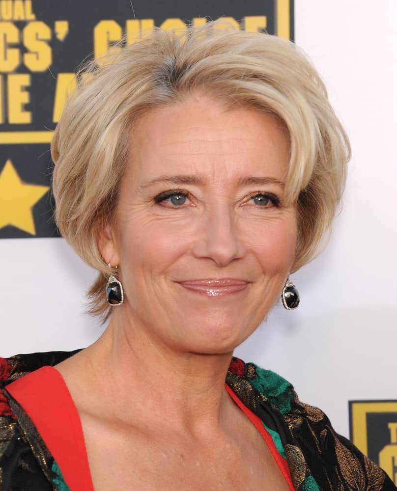 In this next hairstyle, modeled by Emma Thompson, it features a short-cut length that touches the nape of the neck. This short hairstyle is complemented by a light blonde color, in addition to slivers of silver highlights. In order to frame the face of the wearer and add volume, curls are added away from the face. 