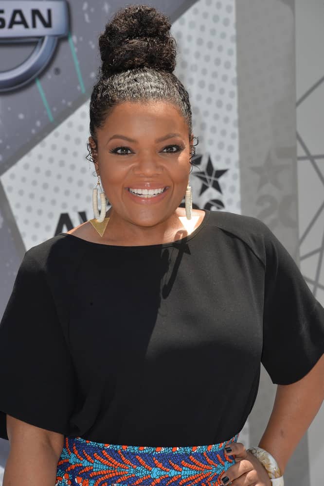 Working with your natural texture can make a beautiful up-do. Take a cue from Yvette Nicole Brown’s style and add some moisturizing hair serum before brushing your hair up into a hair tie. Loop your hair through once and wrap the ends around the base. Fan out the loop to finish the look. 