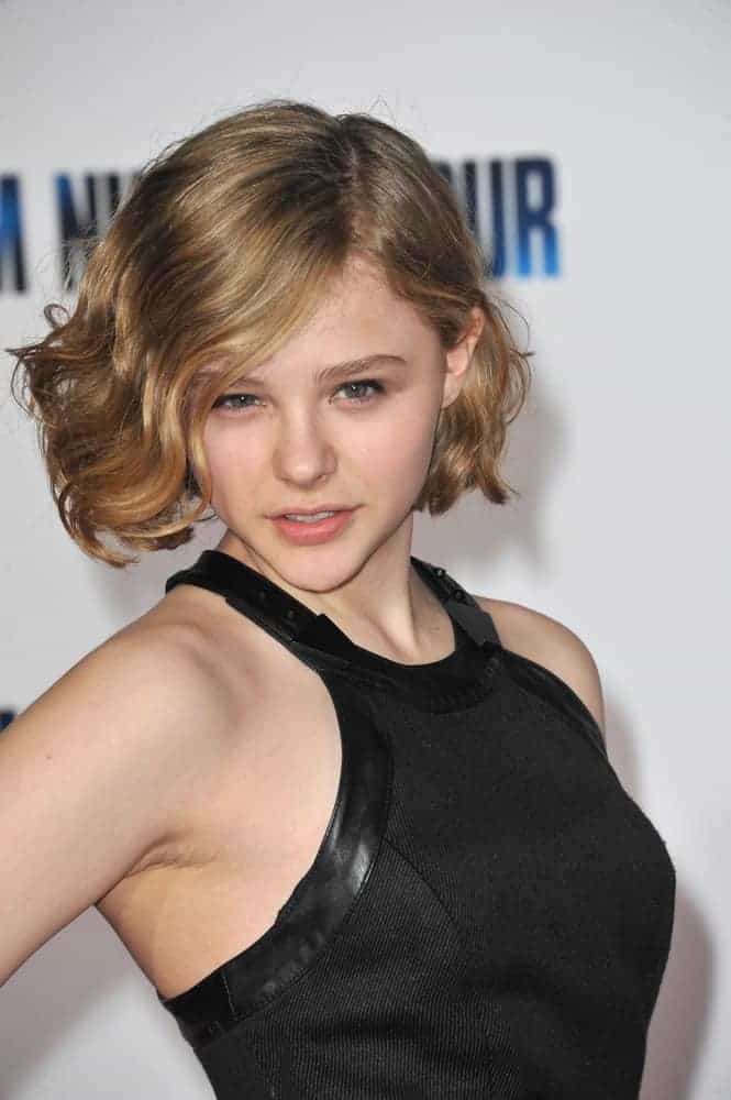 Chloe Grace Moretz was at the world premiere of "I Am Number Four" at the Mann Village Theatre, Westwood on February 9, 2011, in Los Angeles, CA. She was stunning in her black dress and chin-length sandy blonde hair with waves and side-swept bangs.
