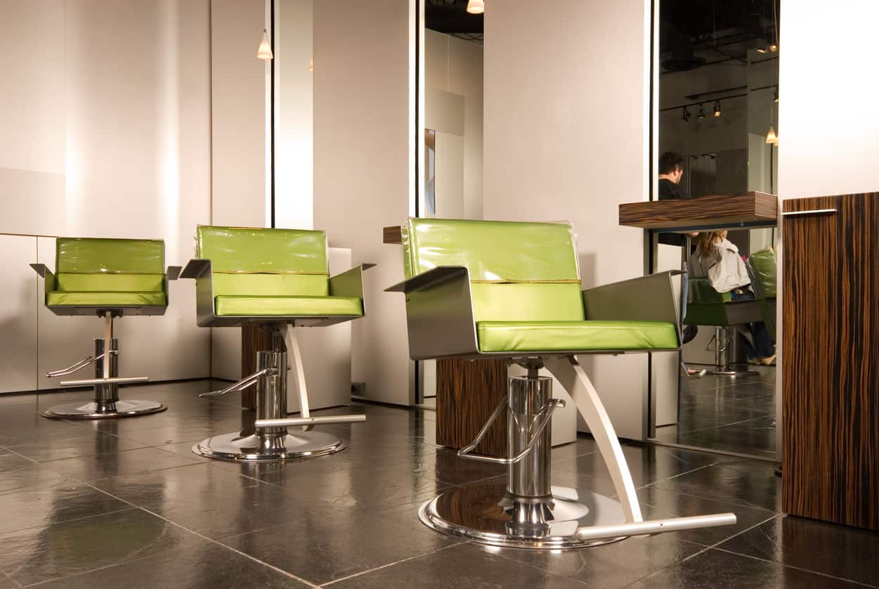 Lime green really draws the eye to it. This salon incorporated the bright hue without overdoing it. It is perfectly paired with the shelves and cupboards, and the stainless steel of the chairs finishes off the look. The dark tiled floors and plain white walls help pull this modern look together. 