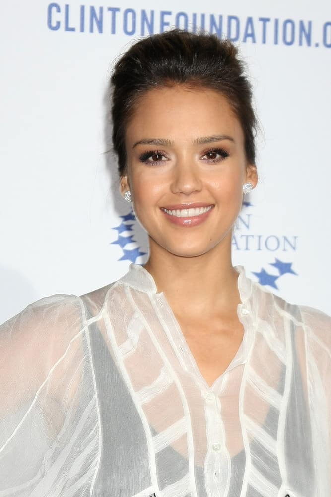 Jessica Alba was quite charming in the white sheer outfit that she paired with an elegant upstyle bun hairstyle with slight tousle at the Clinton Foundation “Decade of Difference” Gala at the Hollywood Palladium on October 14, 2011, in Los Angeles, CA.
