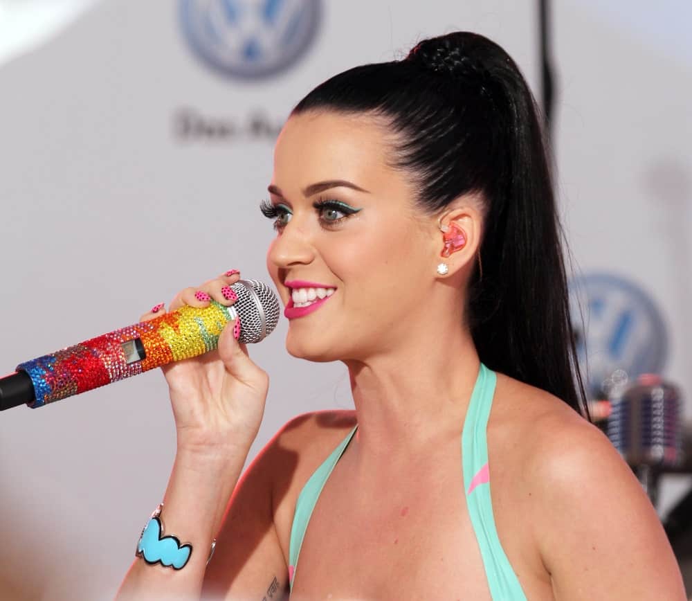 The singer performing at the world premiere of Volkswagen’s new Jetta compact sedan at Times Square on June 15, 2010 with her long jet black hair slicked back into a high braided ponytail.