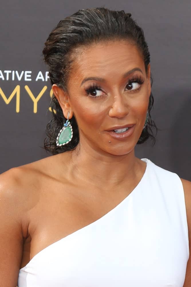 Mel B looking sleek in a brushed back half upstyle that she wore during the 2016 Creative Arts Emmy Awards - Day 1 - Arrivals on September 10, 2016. She topped it off with a white halter dress and oversized earrings.