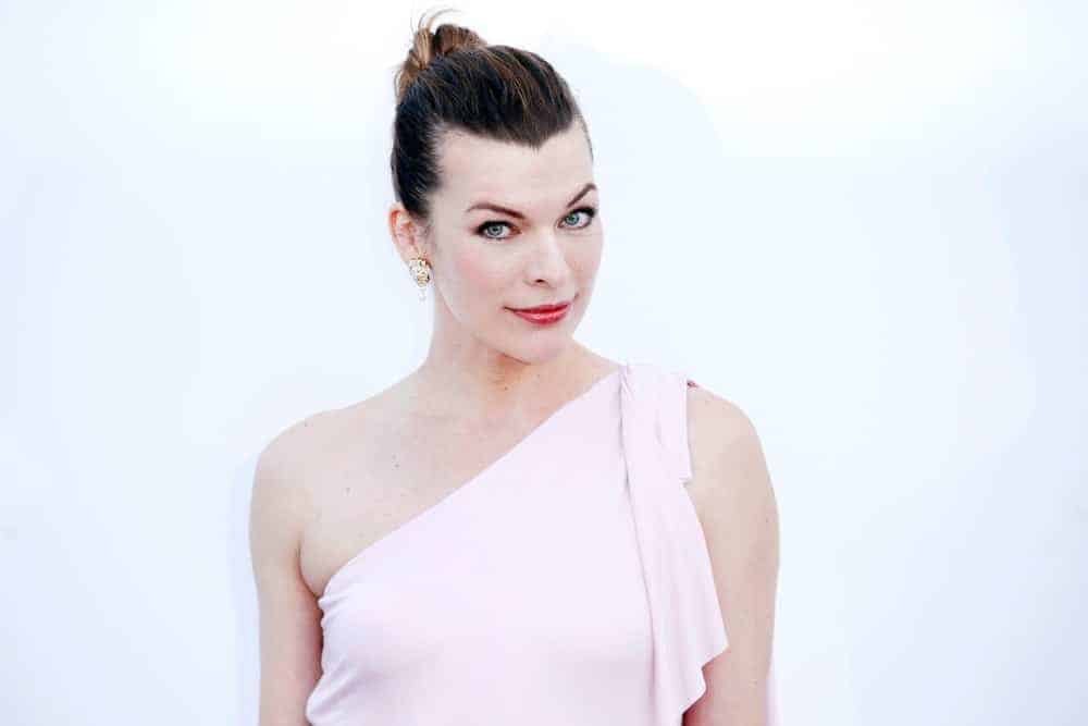 Milla Jovovich was at the amfAR Gala Cannes 2018 at Hotel du Cap-Eden-Roc on May 17, 2018, in Cap d'Antibes, France. She wore a white gown that she paired with her slicked-back bun hairstyle.