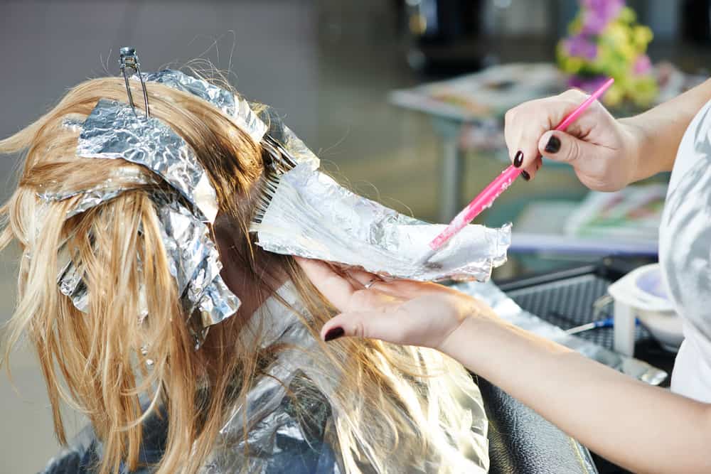 woman getting hair colored in hair salon