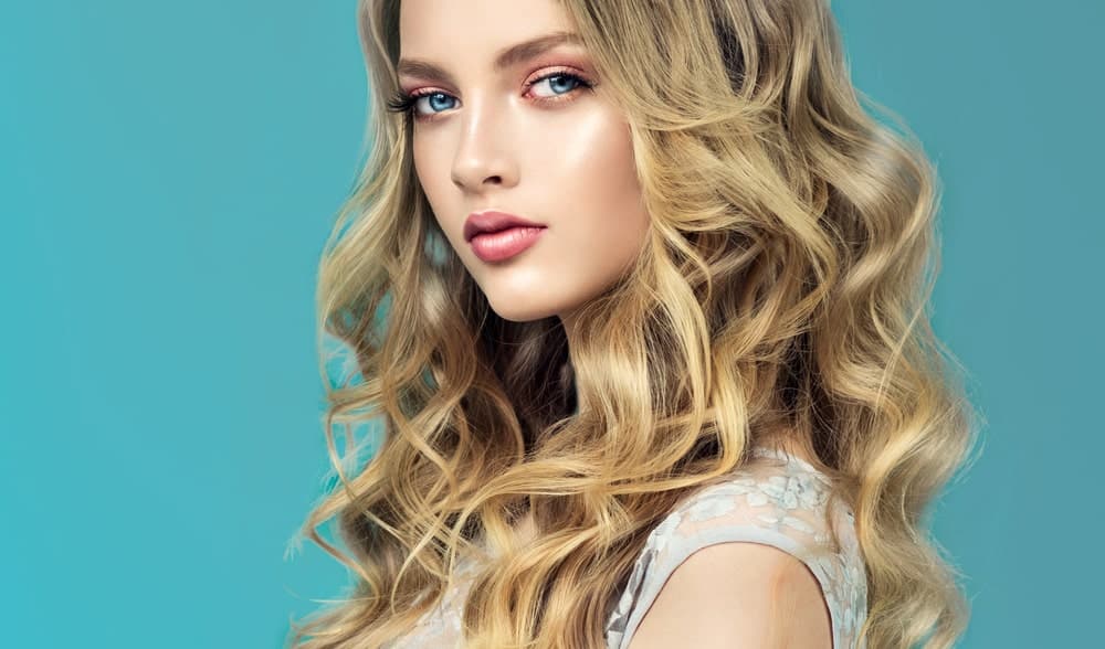 One of the most popular hairstyles for blondes, beachy waves look natural, cool and super sexy. You can use barrel curls to give your hair some loose curls to get this look or blow-dry it to achieve the tousled, seaside look.