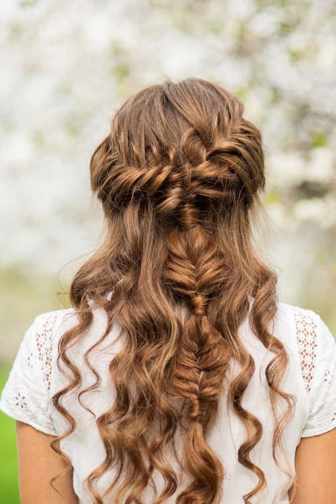 This waterfall braid continues down the back of the head, giving a unique finish among a bed of curls. Definitely something to add a little oomph factor to your hairstyle. 