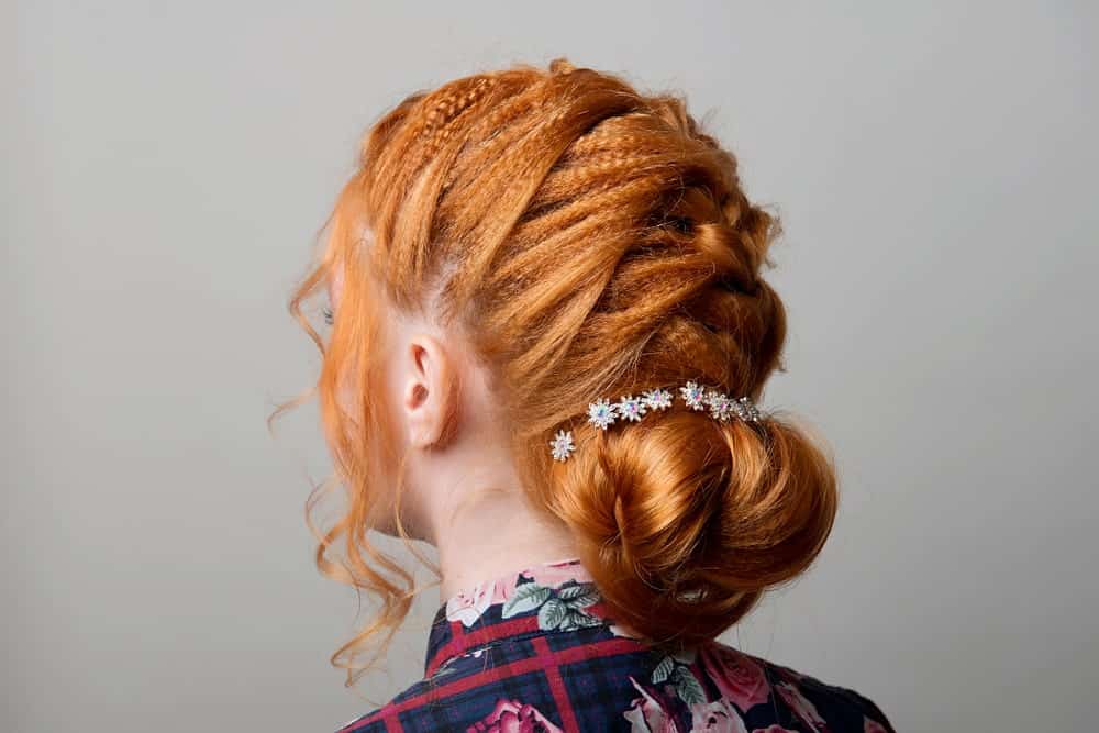 If your hair has dreadlocks, you could consider this beautifully textured updo that braids down the back of the neck and finished with a soft bun at the base.