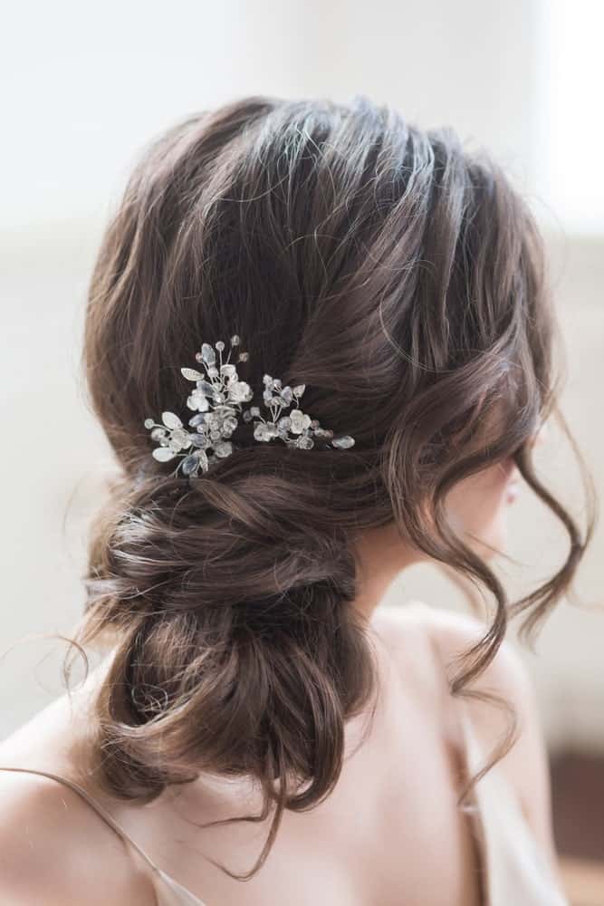 A modern, easy side bun with flowers and curly strands around the face make for a gorgeous hairstyle to go with all types of dresses! 