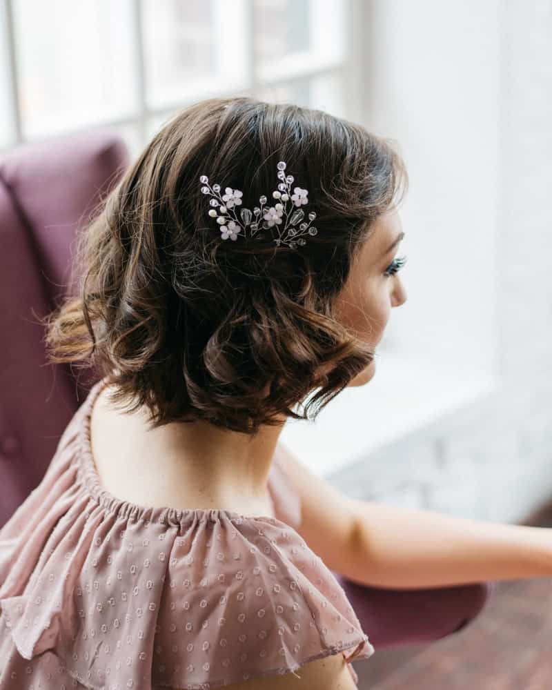 If you have short hair to begin with, you can dress it up with soft curls at the end and a stylish flower accessory. 