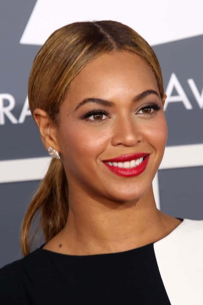 Beyonce rocks a middle parting here as well, but pulls her hair back into a ponytail so her earrings can shine. A great choice for keeping your face the main focus!