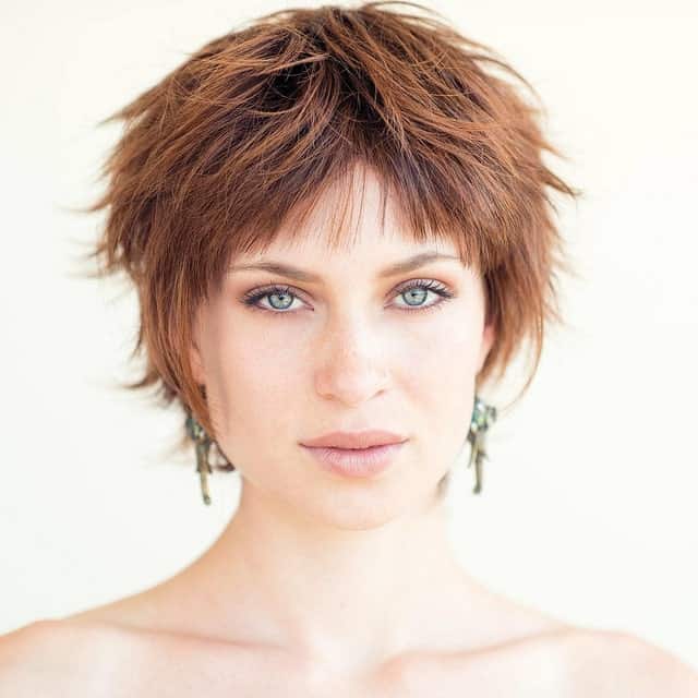 This style of pixie has choppy, unequal-sized hair, giving the cut more definition and volume. The pixie haircut on this young woman is a feathered dream.