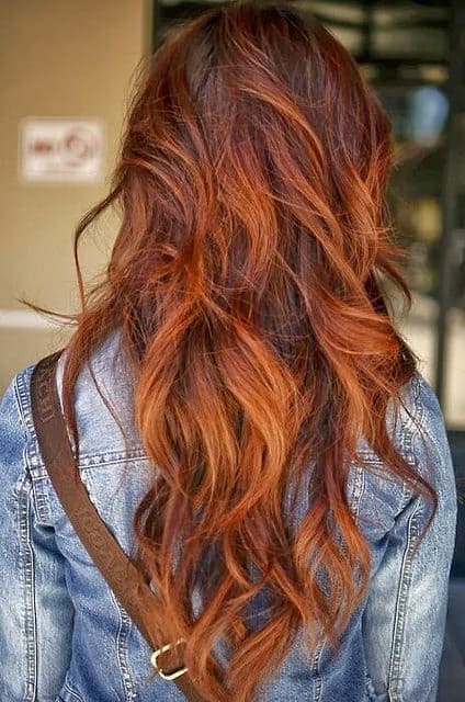 This gorgeous natural shade of red has been enhanced by some judicious balayage treatment. The color incorporates fox red, orange and autumn brown shades for this hot look.