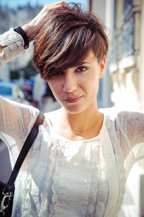 This style of pixie has choppy, unequal-sized hair, giving the cut more definition and volume. The pixie haircut on this young woman is a feathered dream.