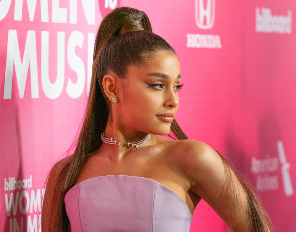 The singer’s iconic hairstyle feature a half up, half down hairdo featuring a sleek ponytail at the top of her head and a split sleek parting of her hair down either shoulder for a polished finish. 