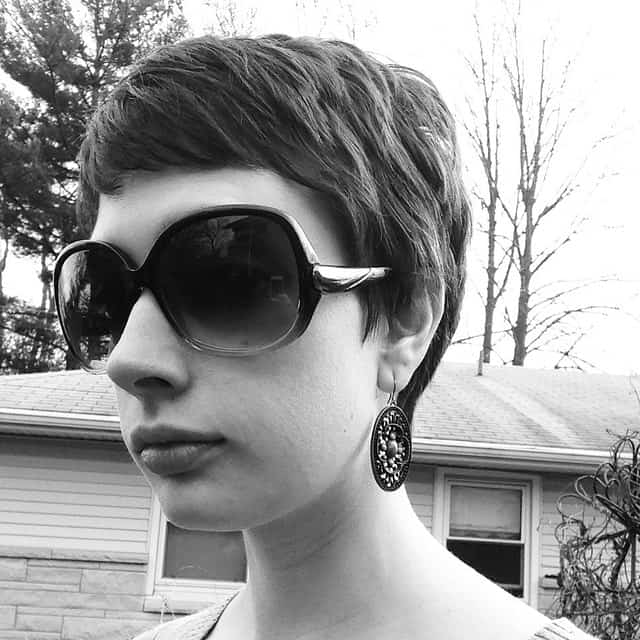 This pixie cut is super-short in the back and longer in the front, like a reverse mullet or tellum. This is a perfect compromise for those people who want to keep their hair off their nape but also want to frame their forehead.