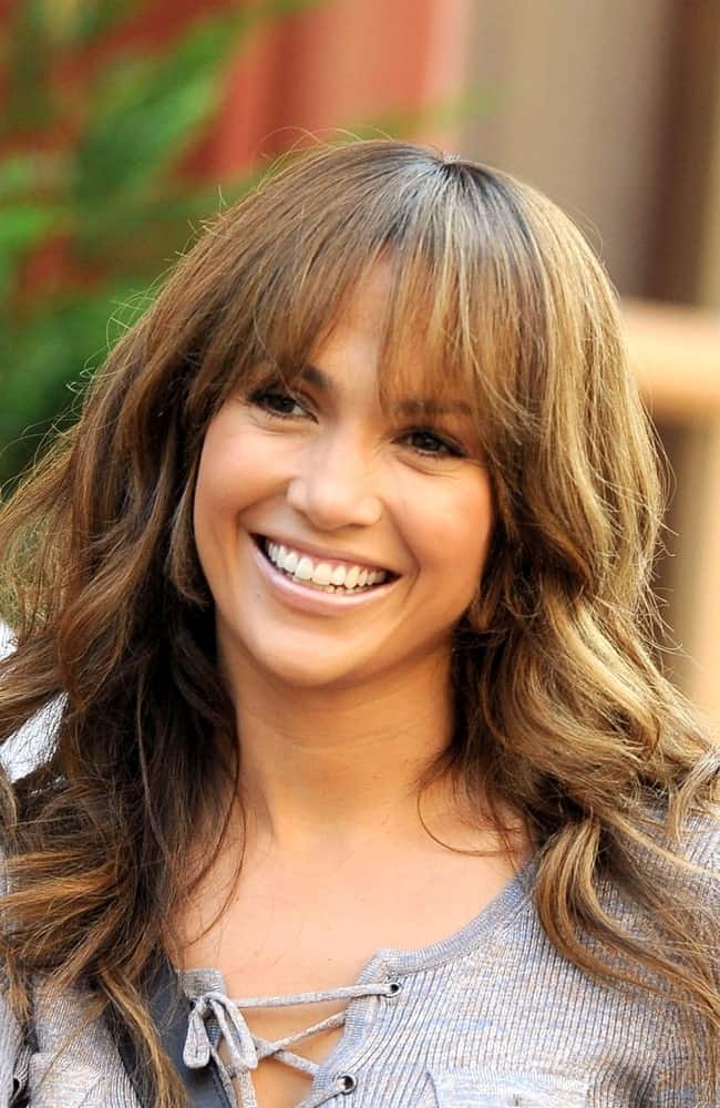 Jennifer Lopez has one of the most versatile faces in the industry. The actress looks great in whatever she wears, hairstyle no exception. To copy the look, keep your front bangs light, airy and straight. Style your locks into long, flowing beachy waves.