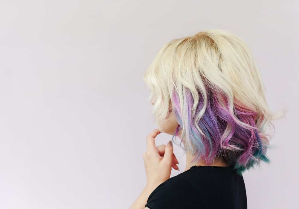 This may not be for everyone, but the stunning strokes of purple, blue and green colors on the platinum blonde head, seem just perfect for this young girl.