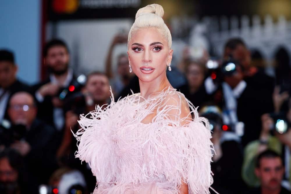 Don’t want your hair falling on your face and neck? Keep it simple and sweet with a tight topknot like Lady Gaga. The pushed back hair enhances the cheekbones like nothing else.