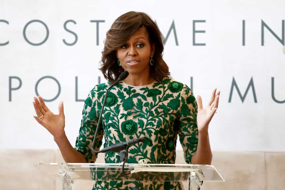 The ever-elegant former first lady shows you how to keep your bangs curled back and elegant. Get your stylist to give your hair some loose curls, like Michelle. Make a deep side part and curls the hair to the side with a curling comb.