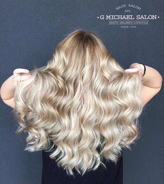 The several hues of platinum, buttery yellow and sun-kissed yellow, coupled with the tousled locks, make this perfect beach bombshell balayage. This young woman looks ready to hit the sun, surf and sand.