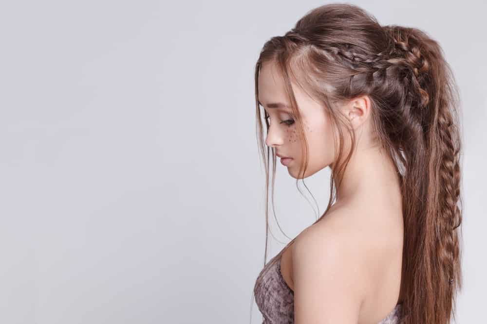 This beautiful hairstyle takes inspiration from bohemian hairdos with a few different combinations of braids that are twisted and pinned along the ponytail. The overall look is trendy and fun while still being pretty enough to turn heads. 