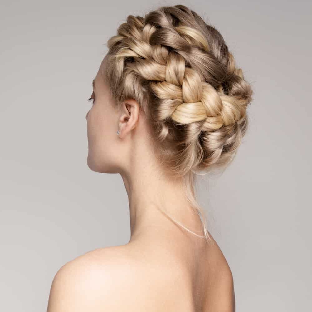 This beautiful braided updo is created by twisting your hair into a braid from one side and bringing it to the other side, forming a full crown of braid around the head. This lovely hairstyle will make you feel like a princess.