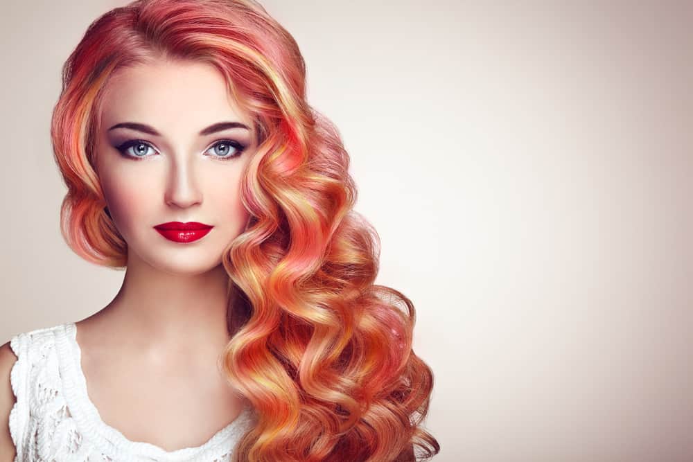 A model with red and pink curly hairstyle