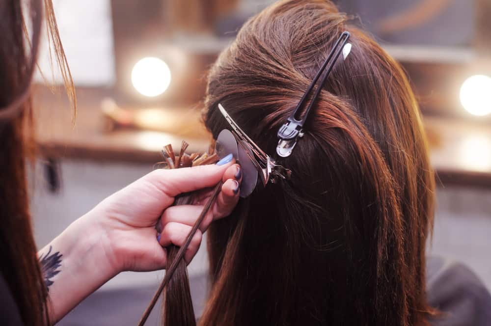 Dark haired woman getting extensions