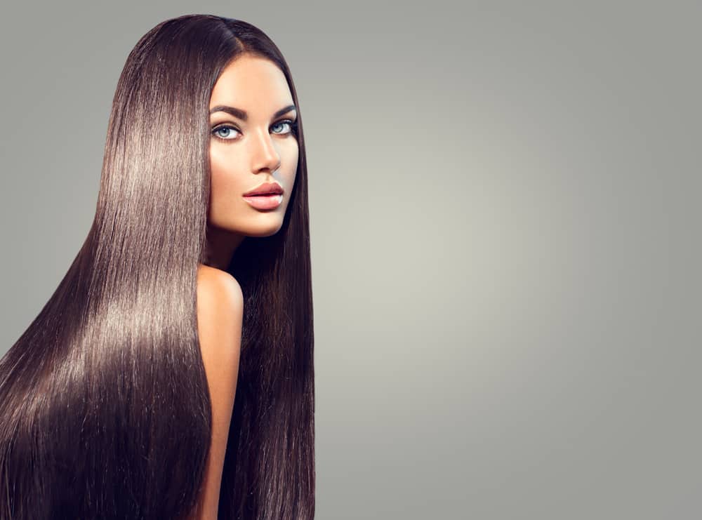 A young woman with dark brown and straight extensions