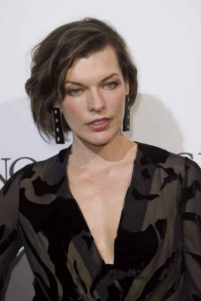 Milla Jovovich attended the De Grisogono Party at the annual 69th Cannes Film Festival at Hotel du Cap-Eden-Roc on May 17, 2016, in Cap d'Antibes, France. She wore a black patterned dress with her tousled chin-length hairstyle that has side-swept bangs.