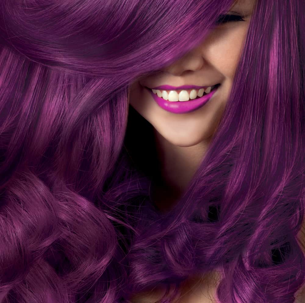  a woman flaunting her purple hair