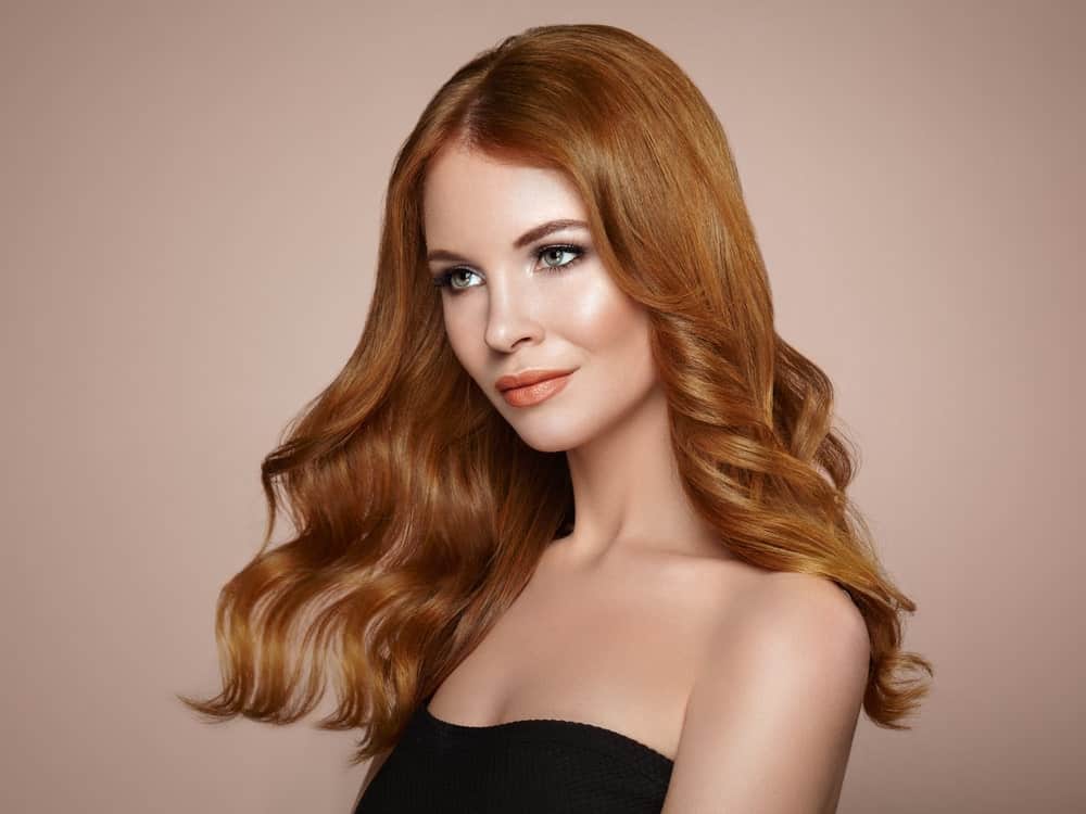 This is a classic, elegant haircut that will suit just about anyone. The shoulder-length soft curls standout in the auburn color. 