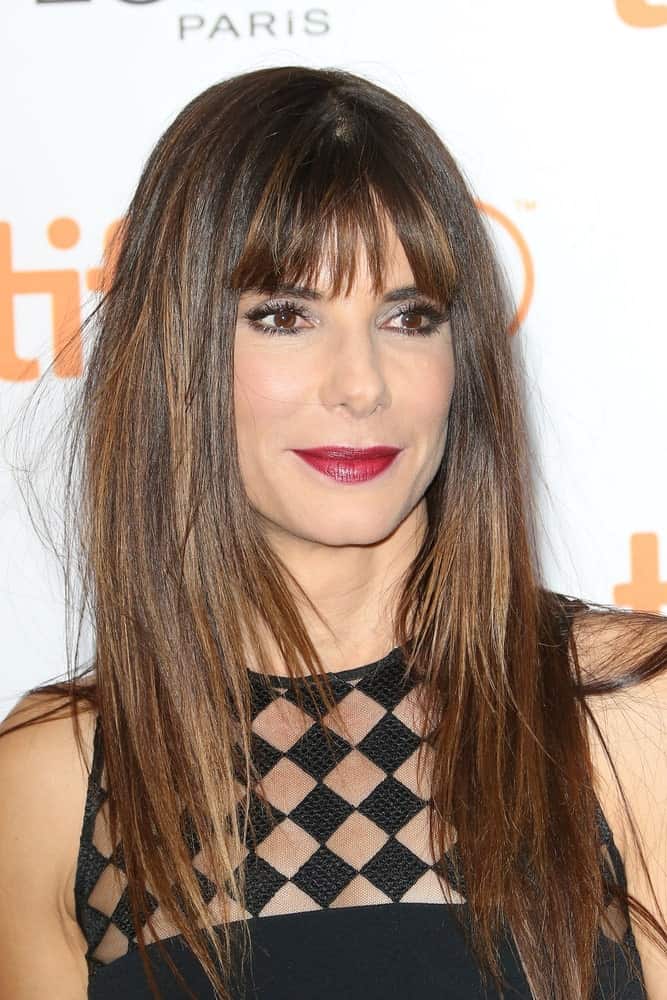 Sandra Bullock is one of Hollywood’s top leading lady with stunning straight hair. Be it an award show or a film premiere, she always sets an example of why it’s best to wear straight hair down. Here, she pairs the simple style with blunt, airy separated bangs to take the beauty to a completely different level. 
