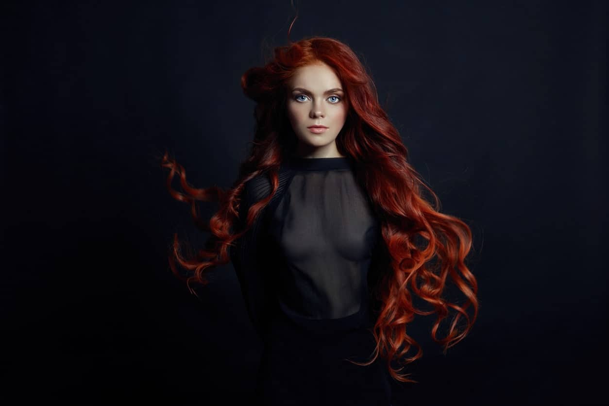 Long hair with messy curls look amazing on anyone but with the auburn color, they look absolutely fiery and powerful. 