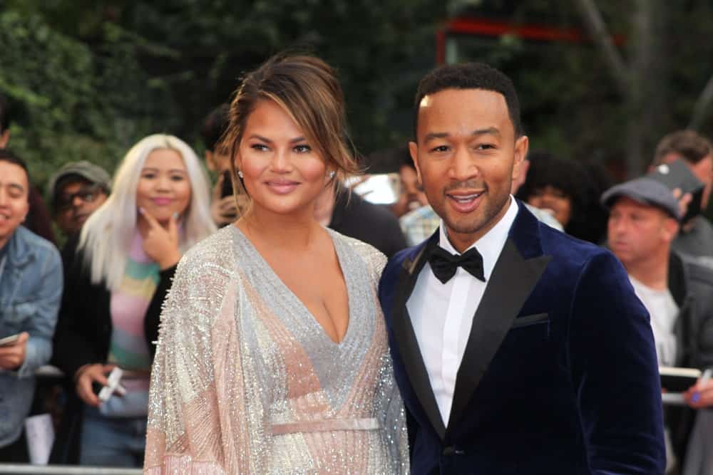 Chrissy Teigen has her hair up in a messy bun with a straight side bang to frame her face perfectly. The soft honey tones in her brown hair look absolutely gorgeous. 