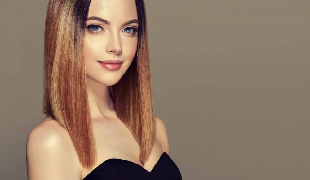 This angled lob has so many colors, it looks like there is a full palette of red, brown and blonde dyes in there. This beautiful woman is rocking an ultra-modern lob that skims her shoulder at the back but is angled and cut much longer in the front. This style is super attractive and super sophisticated.