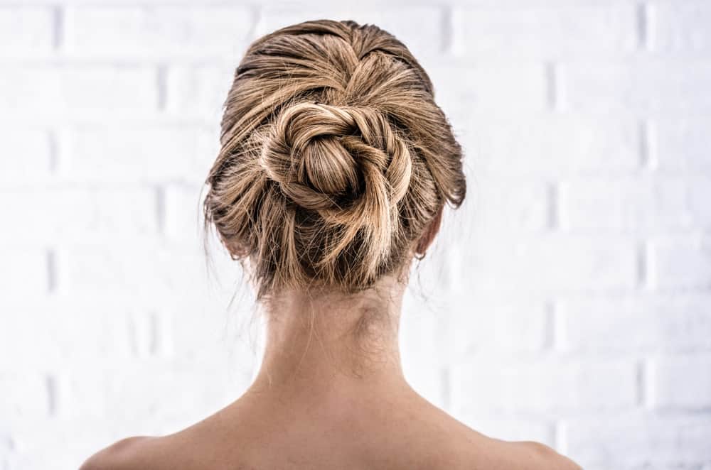 The perfect marriage between a braid and an updo, this knot looks quite complicated — but it is actually not. To get this look, start a French braid from the very top of your crown. Then twist the braid into a figure-8 knot and secure it with bob pins. A great wedding hairstyle is done in just a few minutes!