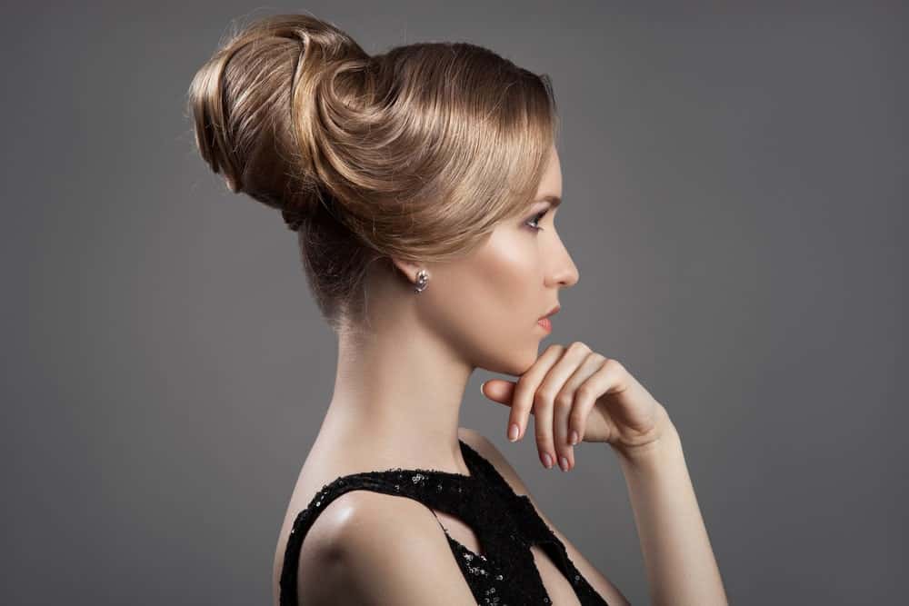 Do you want to get ready for a party or a wedding but don’t know how to style your hair? If you have a long, glossy mane, here is a great style. Ask your stylist to pull your hair back in an elegant updo that curls in on itself and ends with a pseudo beehive, like they used to wear in the ‘60s. The antique brown hair color will also enhance the period look.