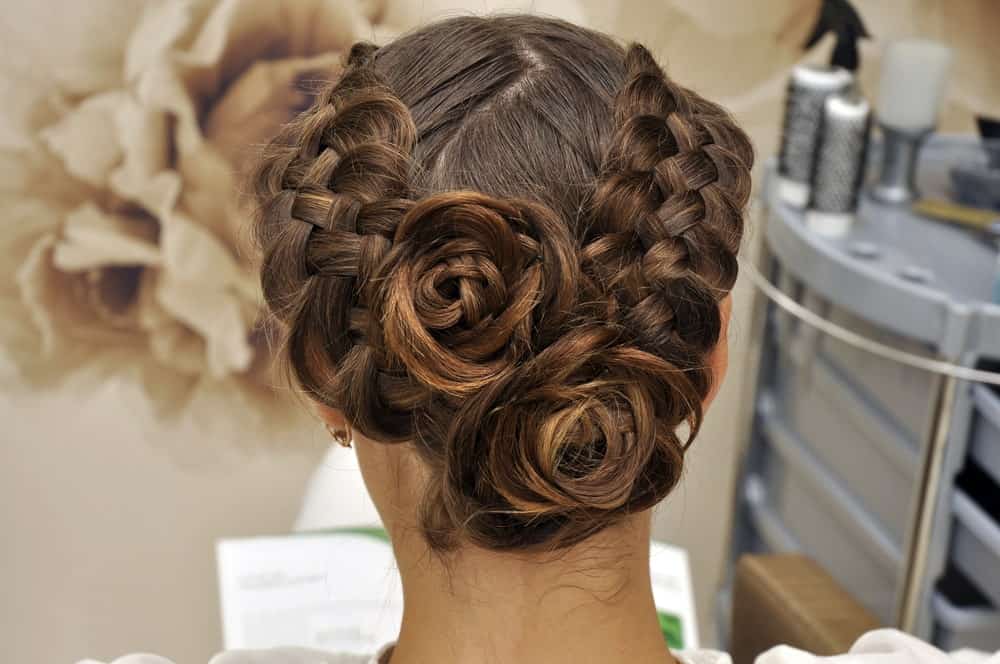 Who wouldn’t love some lovely roses? This hairstyle for long brunette hair can take your love for flowers to the next level. It is perfect for weddings or prom-nights. The hairstyle features two thick braids which start in the front and end in a formation at the back that looks like roses! If you are looking for a way to add an X-factor to your look for your special event, opt for this hairstyle!