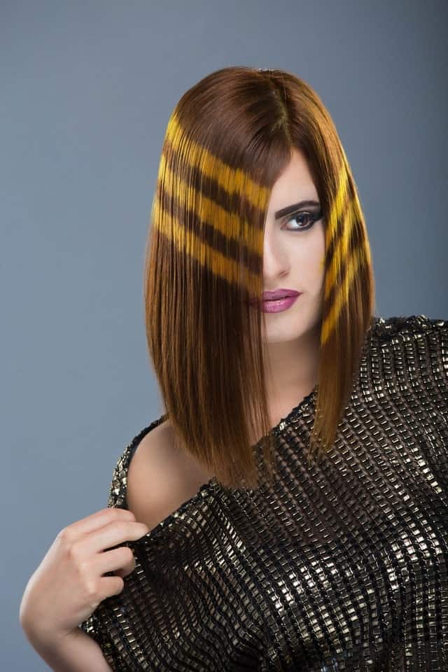 If bright and vivid hair colors are not your style, then consider adding just a touch of flamboyancy as shown in the example above. Note that the key is to get a slant bob for an overall sleek and chic look.
