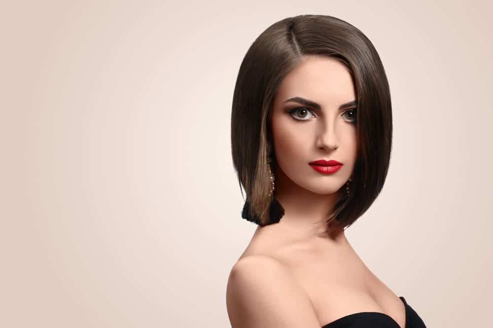 This is another gorgeous brunette bob with a side parting and equal length from both sides. The hair has been back-combed from the top that make it look slightly thick and voluminous.