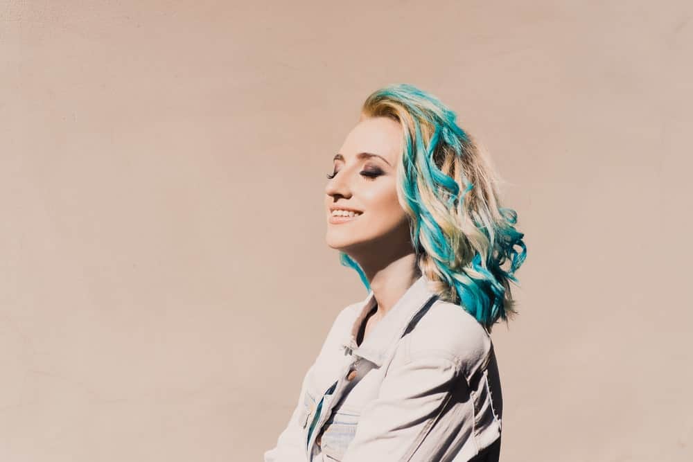 If you want to go for an unconventional, radical look, try a piece-y colombre. You can achieve the effect by asking your stylist to take sections of your hair and dye it in a dramatically different color, like aqua blue.