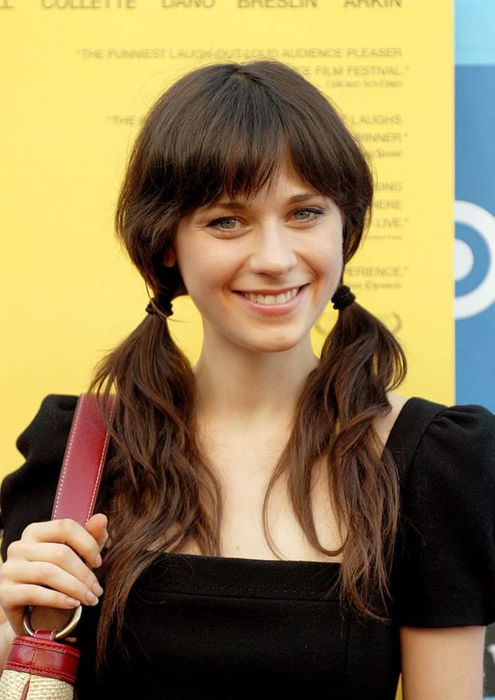 She can never go wrong with bangs. Here, Zooey sports a lovely, refreshing look with bangs and two ponytails. While the bangs bring focus to her eyes, the ponytails add a charming touch.