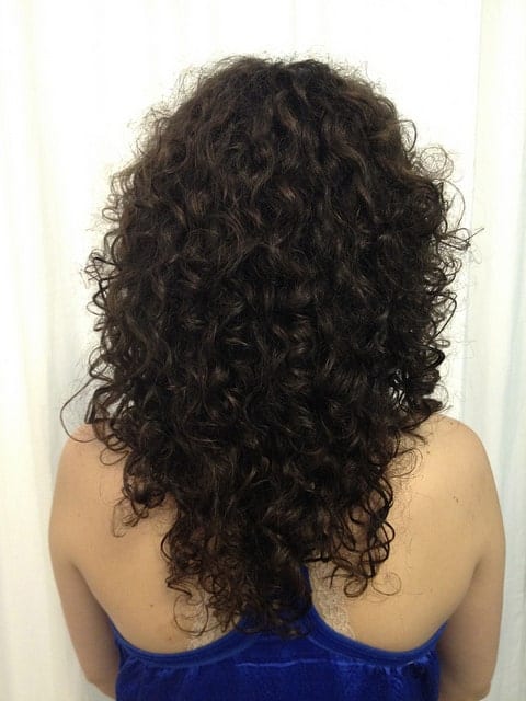 This is a more compact-looking curly hairstyle with small tight curls that are clumped together.