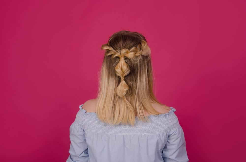 This sweet and casual style is one of the most effortless ways to create a bohemian look. Just take a few locks from the sides of your head and plait them into a loose braid. Then bring them together at the back of the end and tie them together. Twist and tie the loose hair into soft and loose knots.