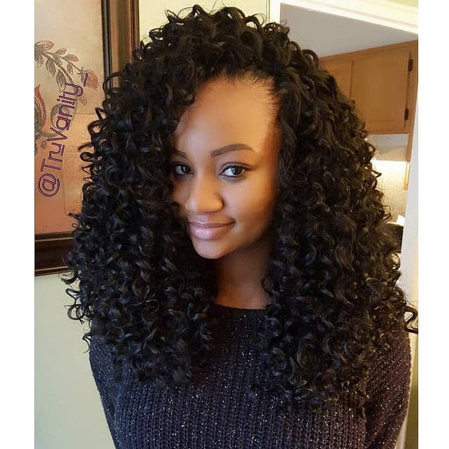 This is a highly voluminous curly style with loose curls at the bottom and super-poofed up hair at the top. 
