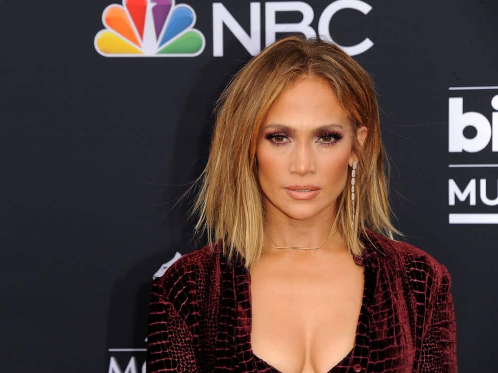 Jennifer Lopez is known as a style chameleon. The singer has a penchant for redefining hairstyles and this one is one of her best looks. The singer dyed almost all of her hair a sandy blonde color that lightened to a light blonde at the tips. To show off the stunning colors, she lobbed her hair short and styled it in a frosted texture.