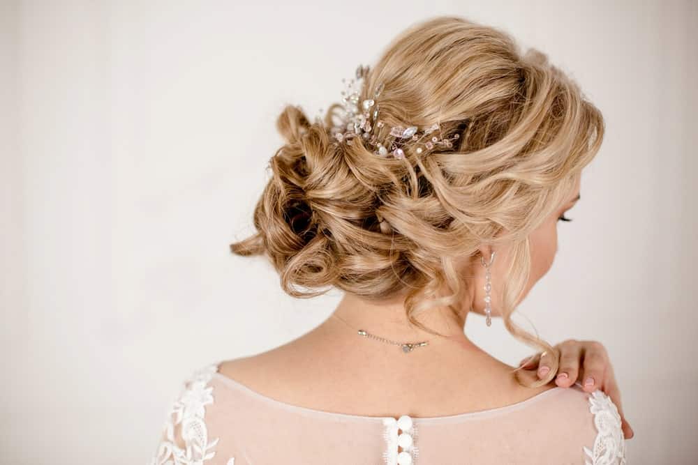 If you have a bit of time on your hands, why not opt for an elaborate updo, if you are attending a party or a wedding? Take a look at this beautiful style filled with knots, twists and turns and embellished with bejeweled accessories.